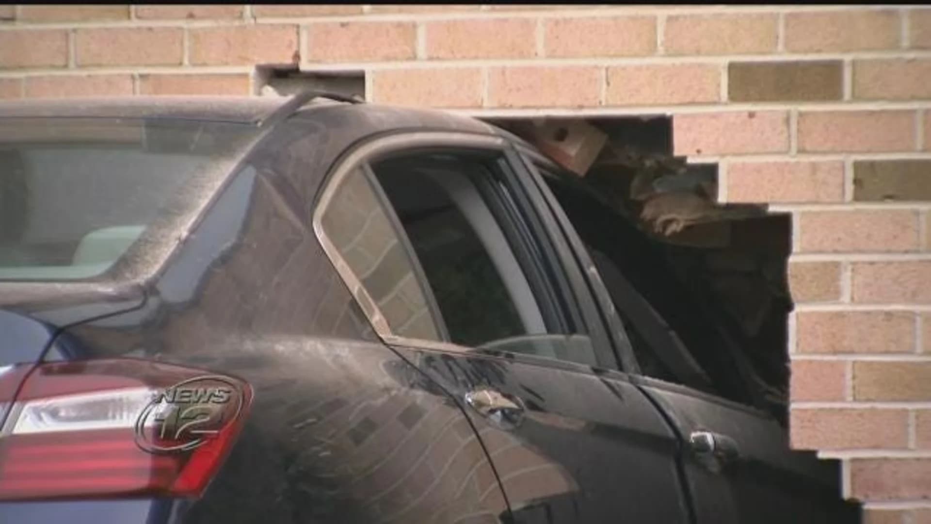 Couple taken to hospital after car rams into building